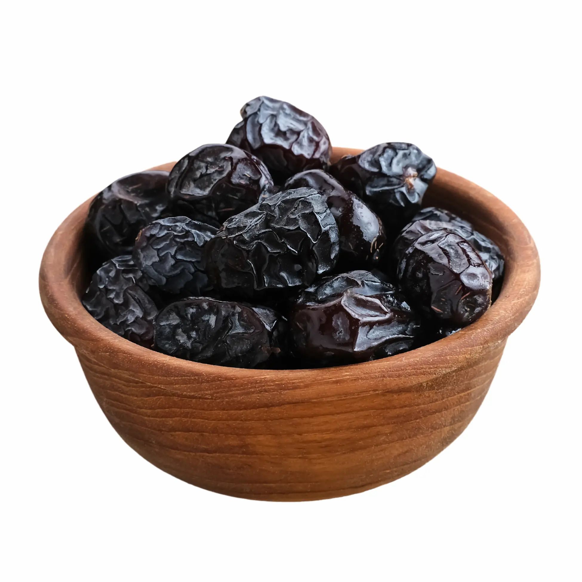 Datteln in einer Holzschale. Dunkle Farbe, runde Form. Nahaufnahme.