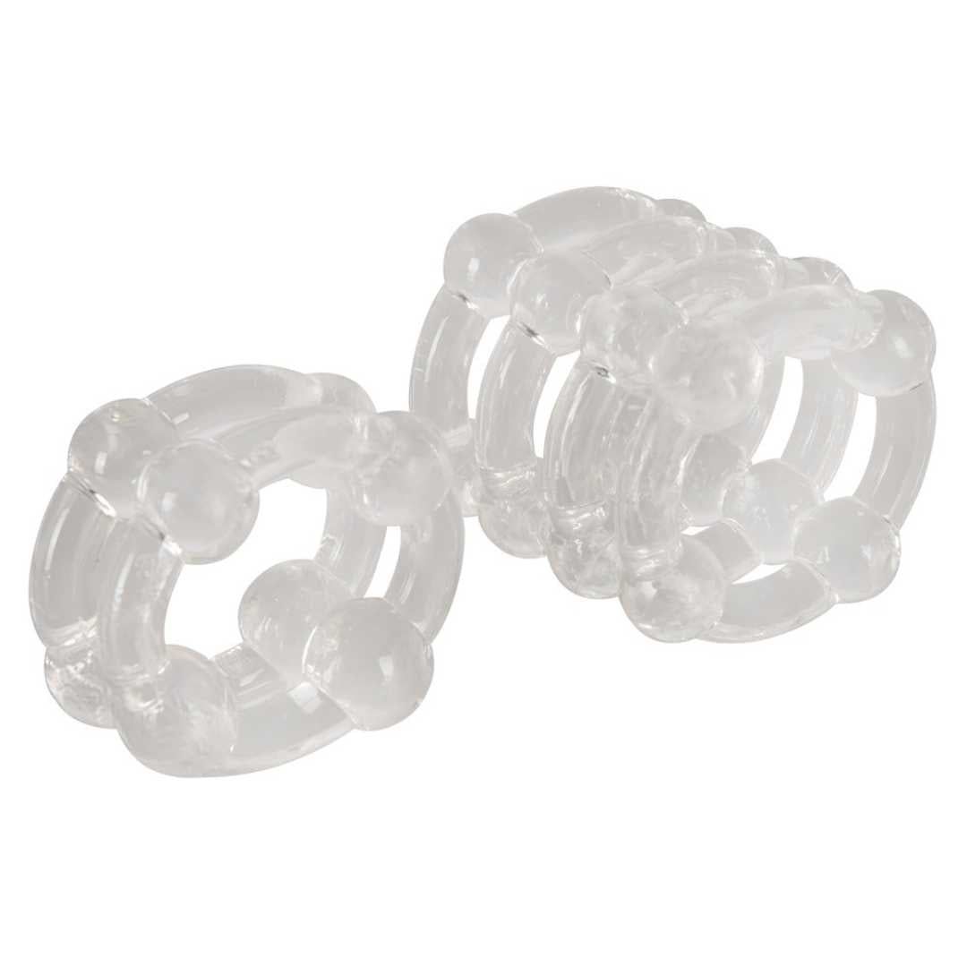 Zwei transparente Ringe mit Noppen. Material scheint Kunststoff zu sein. Ringförmige Struktur mit erhabenen Elementen.
