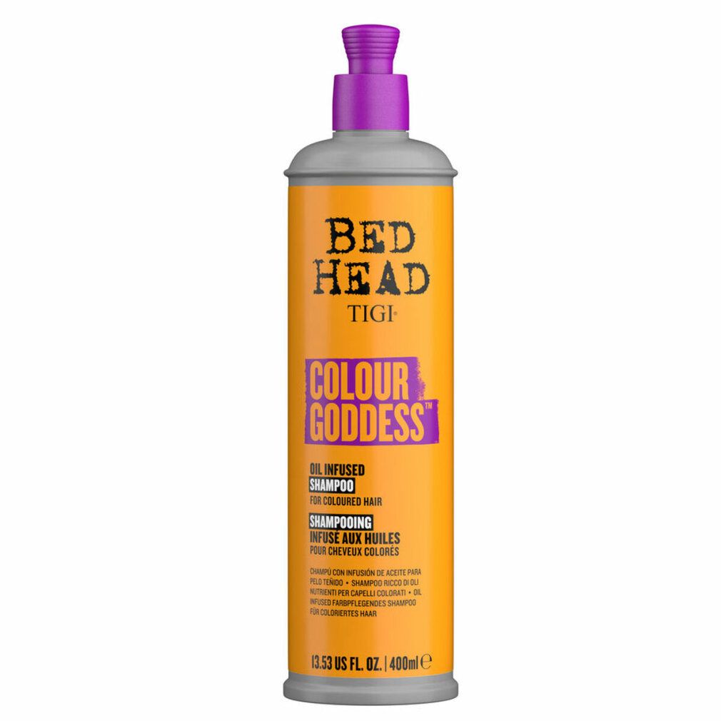 Zylindrische Flasche mit lila Pumpe. Aufschrift: Bed Head Tigi Colour Goddess Shampoo. Orangefarbener Hintergrund.