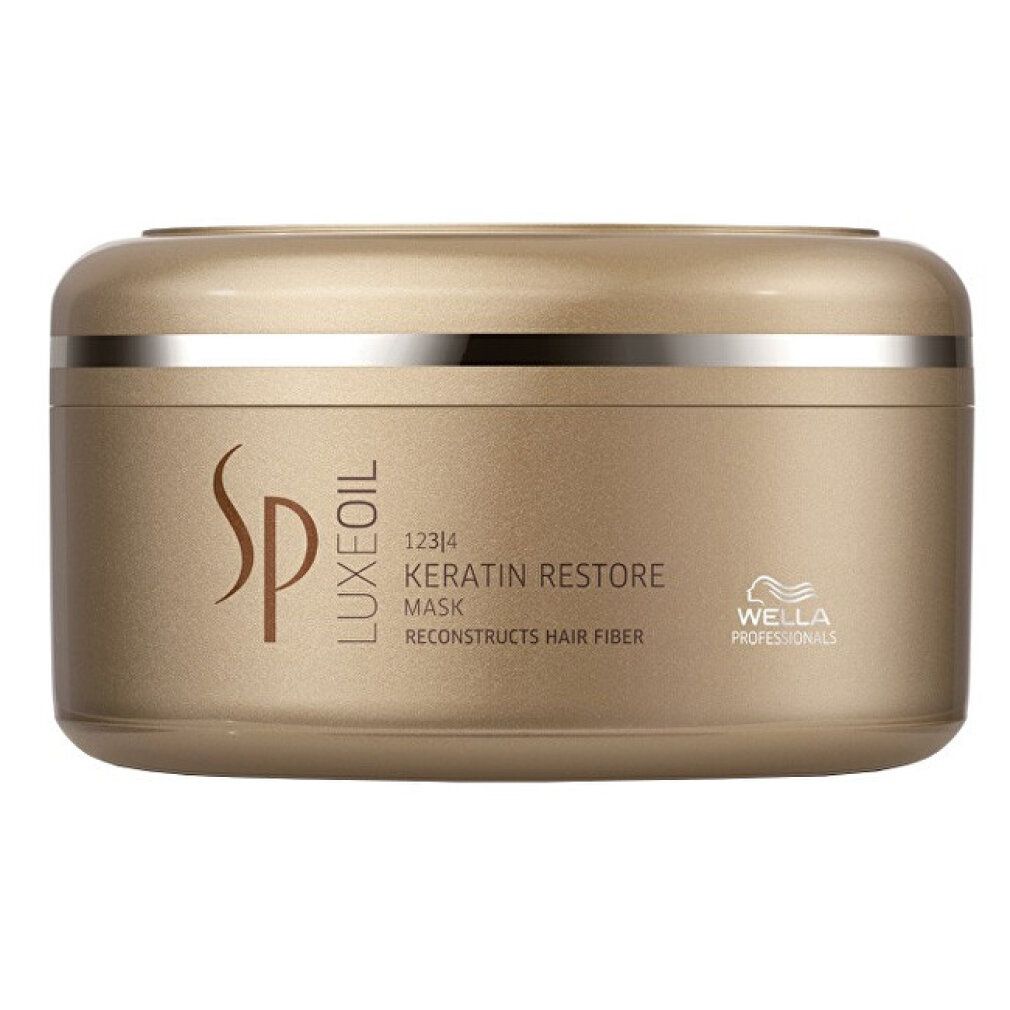 Goldfarbener Tiegel mit silbernem Ring. Aufschrift: SP Luxe Oil Keratin Restore Mask. Wella Professionals Logo.