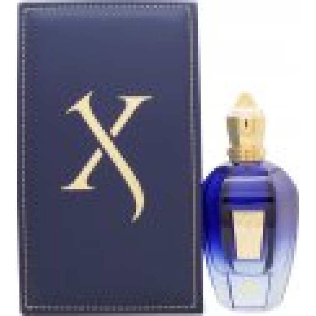 Blau-goldene Flasche und Box. Box mit goldfarbenem 'X' Logo. Flasche mit goldfarbenem Verschluss.