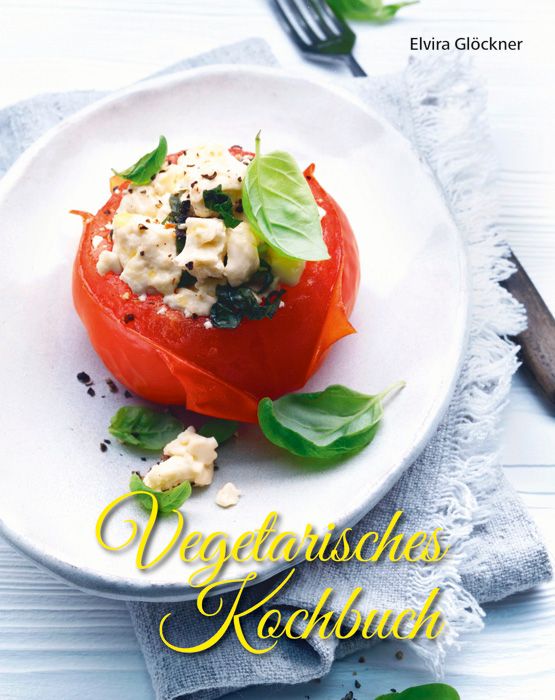Kochbuch mit dem Titel "Vegetarisches Kochbuch". Auf einem Teller angerichtete Tomate mit Füllung und Basilikumblättern.