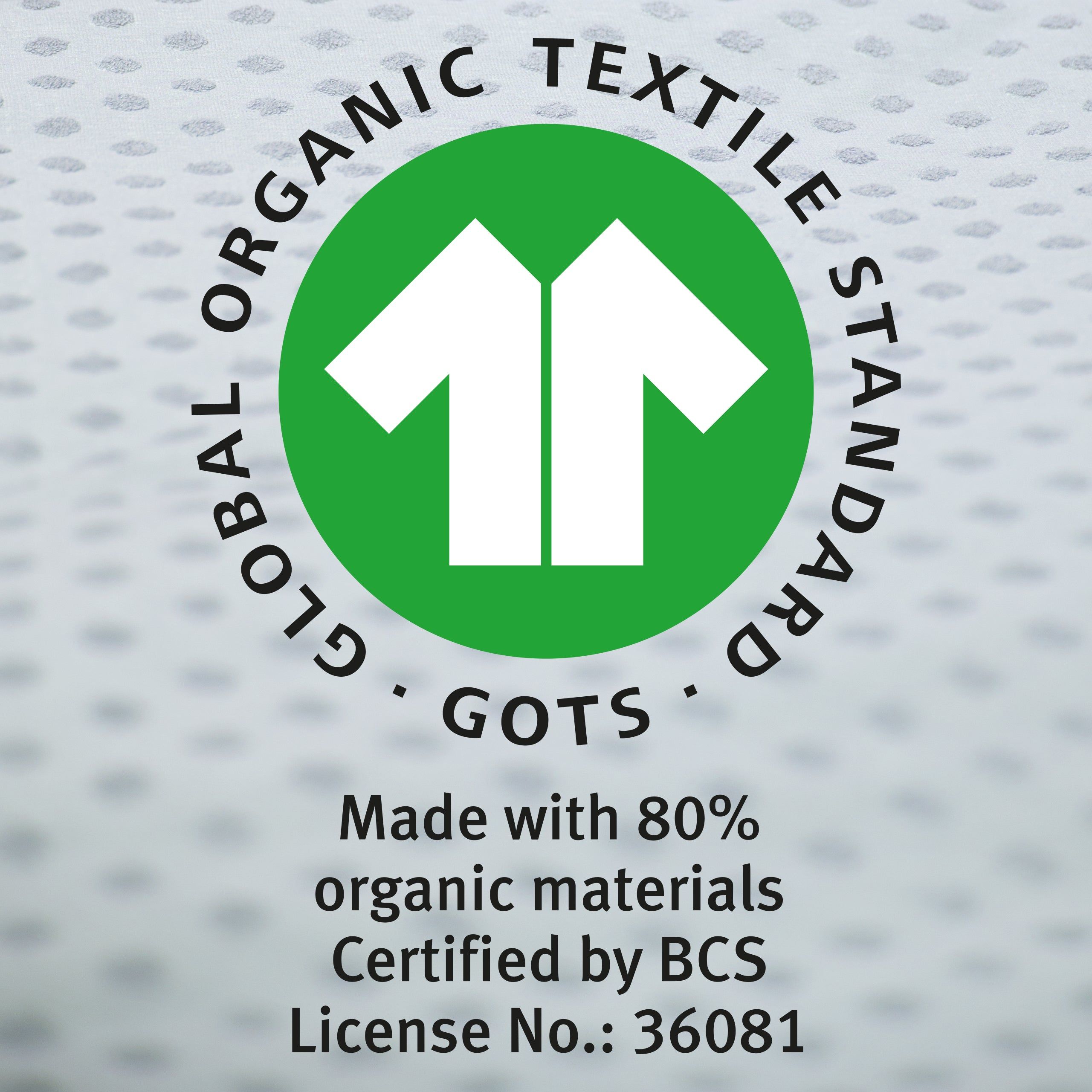 GOTS-Zertifizierungslogo. Grüner Kreis mit weißem Pfeil-Symbol. Text: Global Organic Textile Standard. Made with 80% organic materials.