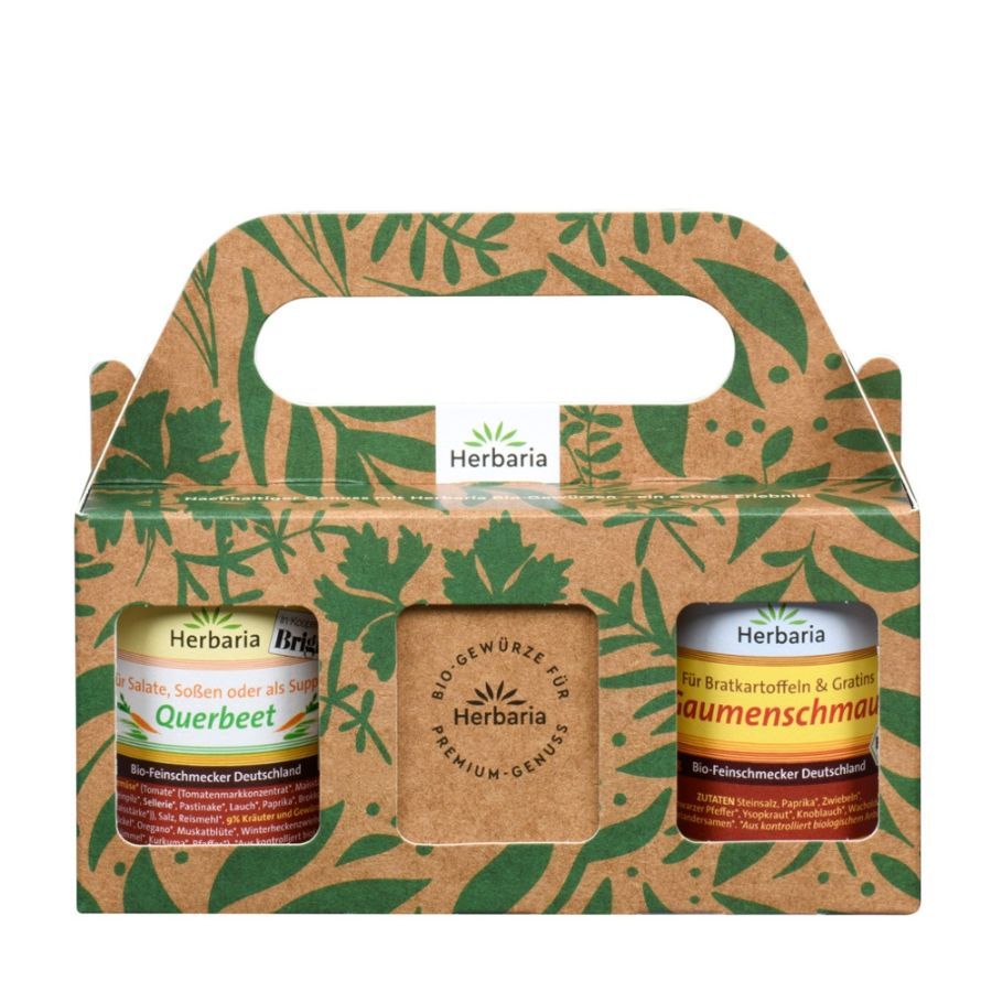 Geschenkset mit zwei Gewürzdosen in einer Pappschachtel mit Tragegriff. Aufdrucke: Herbaria, Bio-Gewürze, Querbeet, Bratkartoffeln & Graumenschmaus.