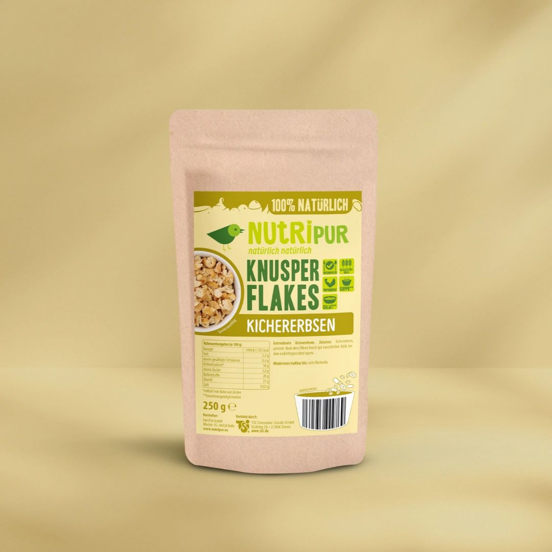 Beutel mit Aufschrift "NutriPur Knusperflakes Kichererbsen". Aufdrucke: "100% natürlich", Logo, Nährwertangaben, Barcode, 250g.