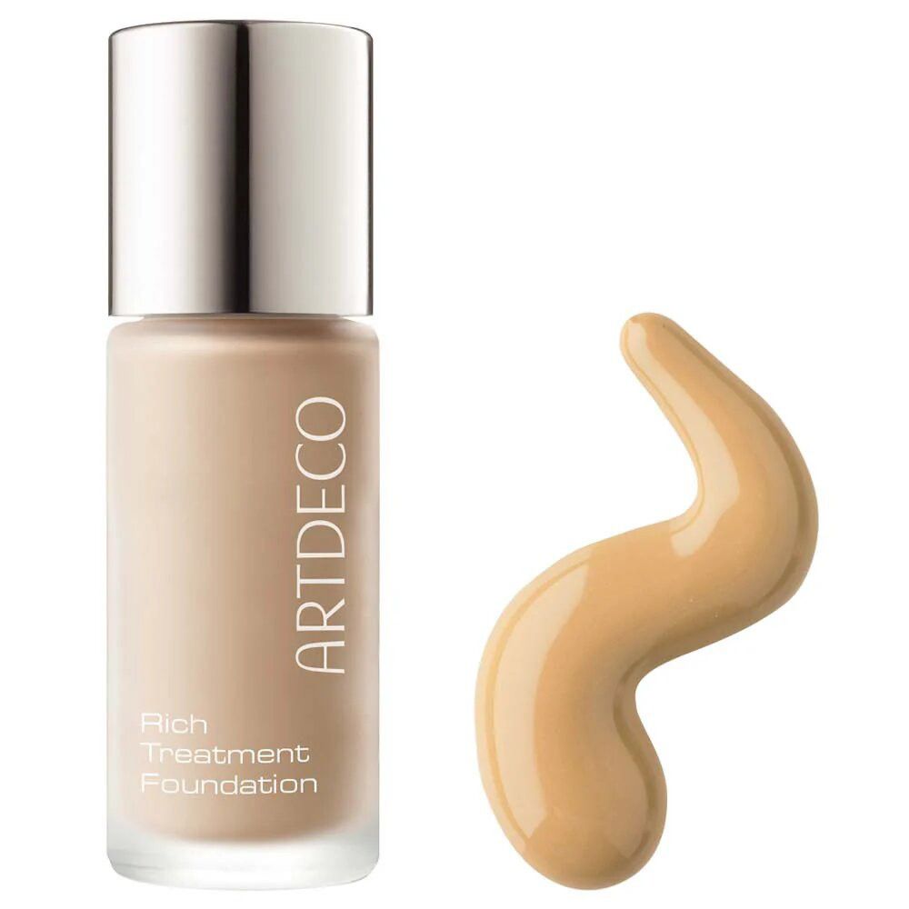 Artdeco Rich Treatment Foundation Flasche und Foundation-Tropfen. Beige Foundation in einer Glasflasche.