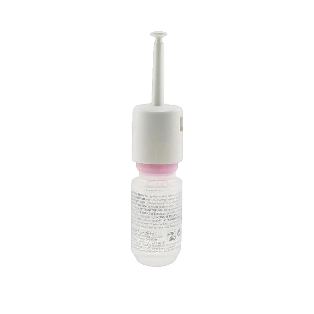 Goldwell Dualsenses Color Intensives Pflegeserum, 18 ml. Einzelampulle mit weißem Applikator. Produktetikett mit Text.