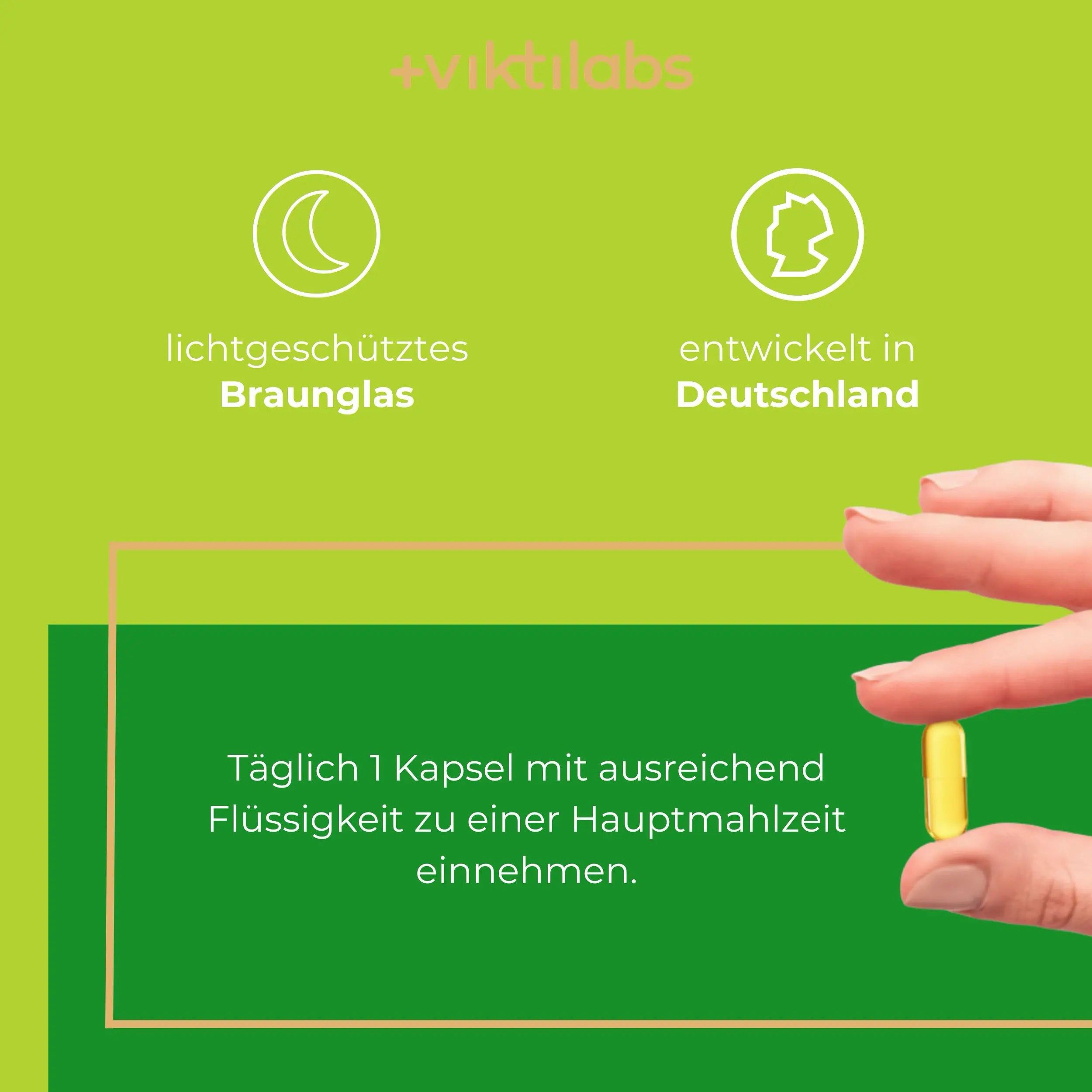 Gelbe Kapsel in Finger gehalten. Lichtgeschütztes Braunglas und in Deutschland entwickelt.