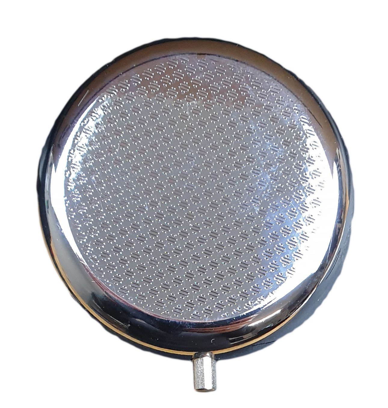 Runde Pillendose, Unterseite mit geprägtem Muster. Metallgehäuse, silberfarben. Mit kleinem Verschluss.