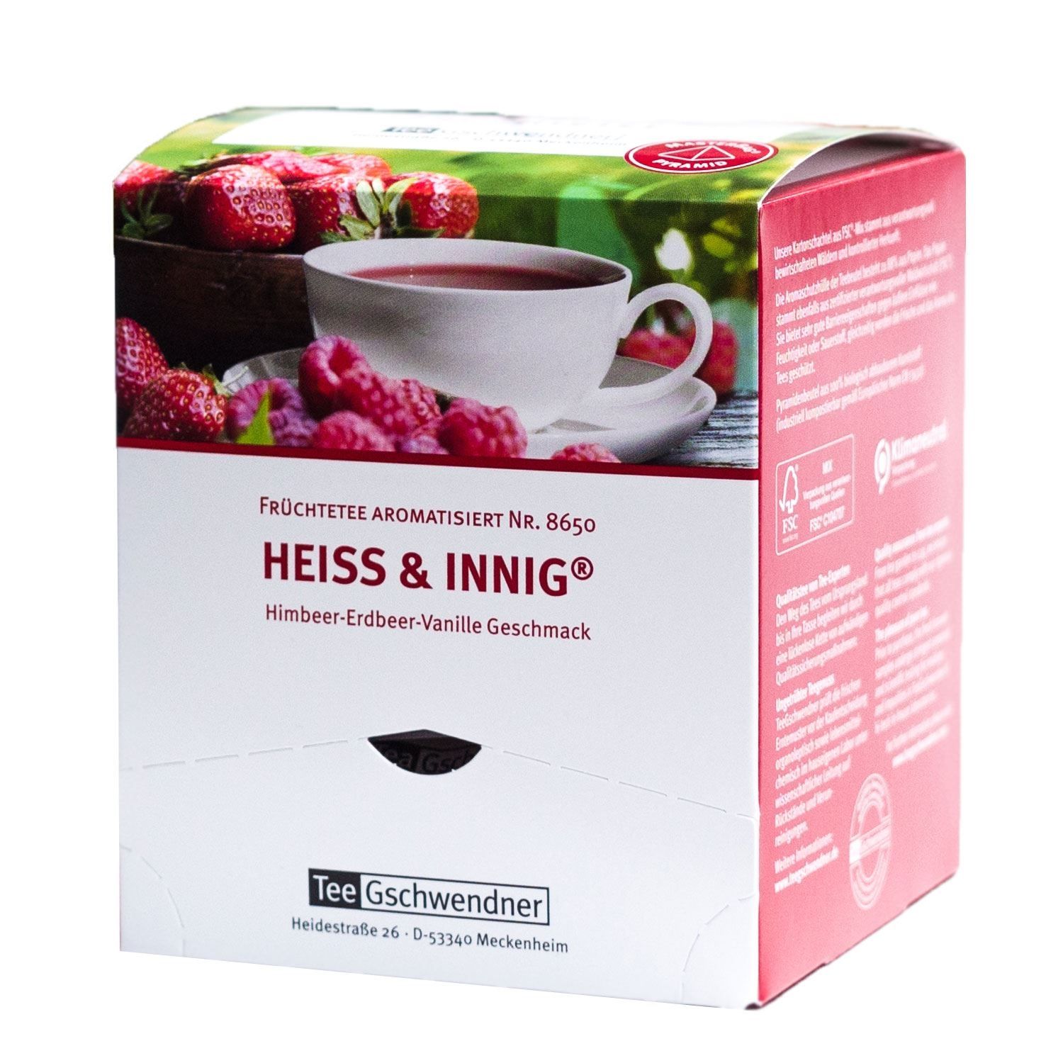 Karton mit Tee. Aufdruck: HEISS & INNIG®, Himbeer-Erdbeer-Vanille Geschmack. Tee Gschwendner Logo. Abbildung von Tee und Früchten.