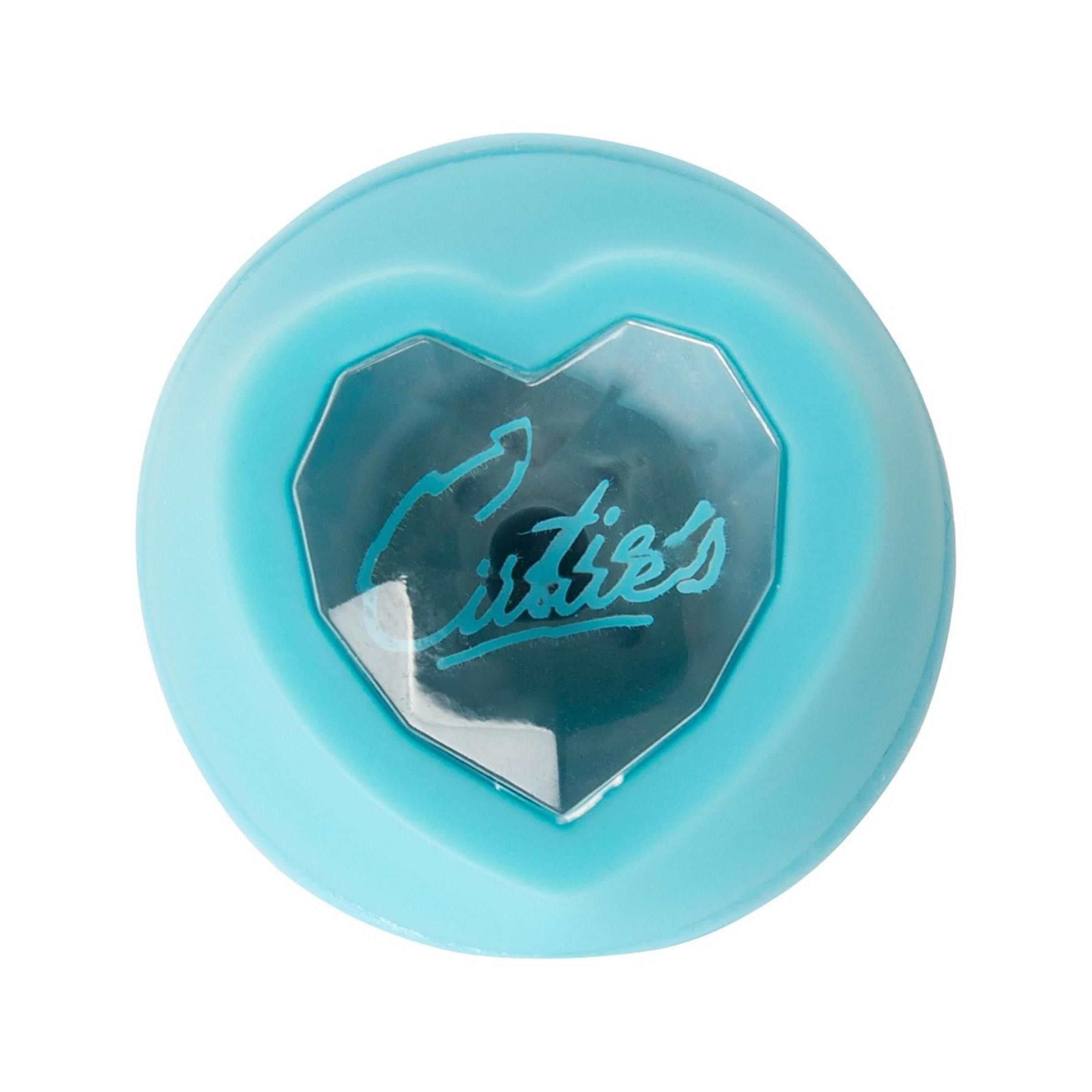 Hellblaues Wellness-Produkt. Runde Form mit herzförmigem Fenster. Schriftzug 'Cuties'.