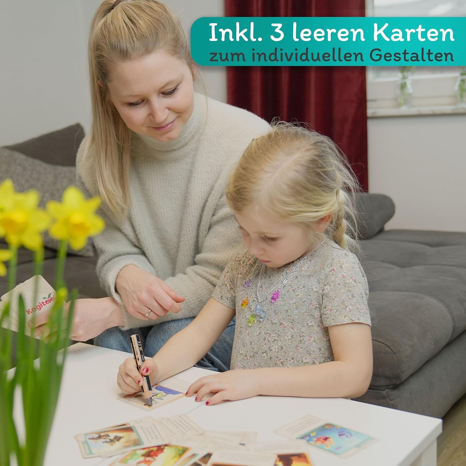 Mutter und Kind sitzen am Tisch und gestalten Karten. Kogitoo-Karten und Stift liegen bereit. Inkl. 3 leere Karten zum Gestalten.