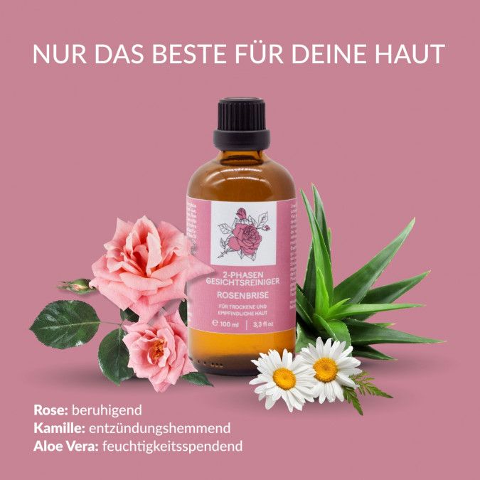 Braune Flasche mit schwarzem Deckel, umgeben von Rosen, Kamille und Aloe Vera. Aufschrift: 2-Phasen Gesichtsreiniger Rosenbrise.