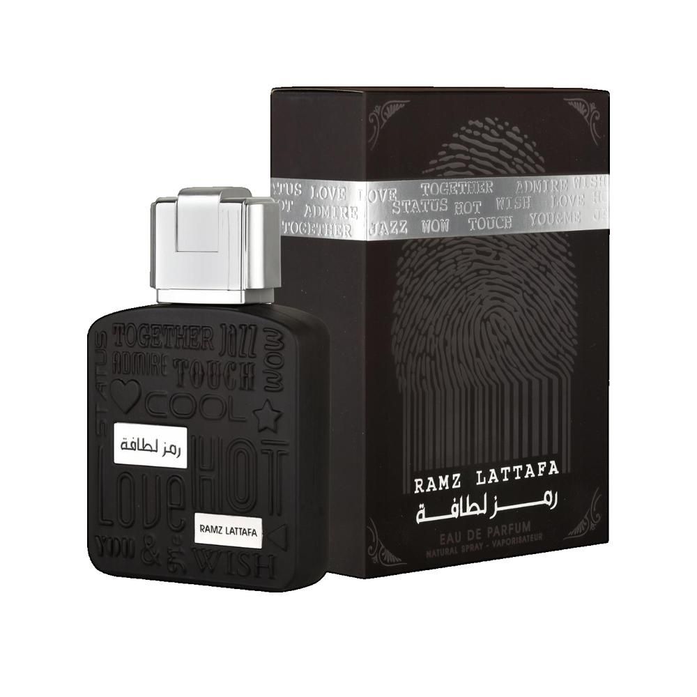 Schwarzer Flakon und Schachtel. Flakon mit silbernem Verschluss. Schachtel mit Fingerabdruck-Design. „RAMZ LATTAFA“.