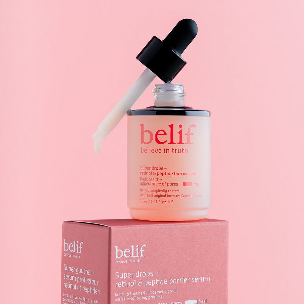 Belif Super Drops Serum Flasche mit Pipette auf einer Box. Rosa und weiß.
