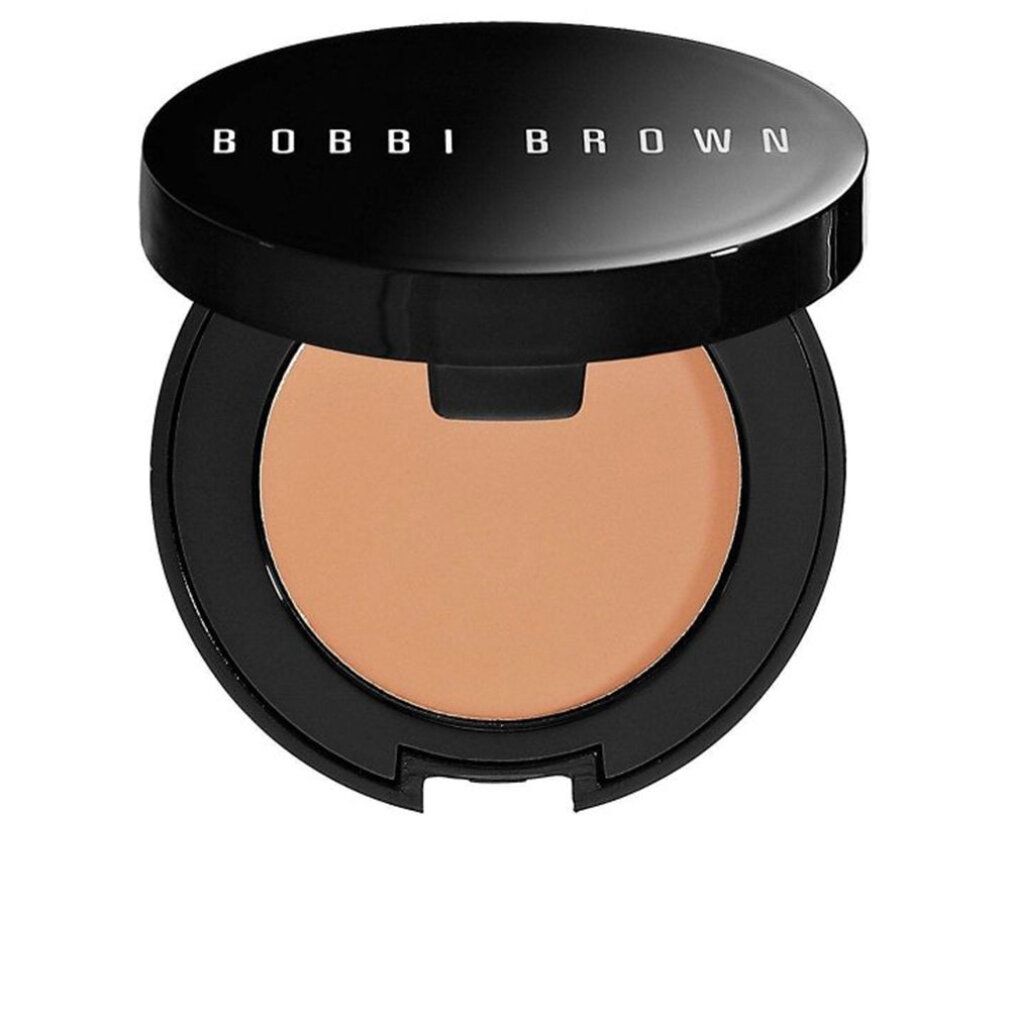 Offener, schwarzer Behälter. Innen: Pfirsichfarbener Corrector. Deckel mit weißem Schriftzug BOBBI BROWN.