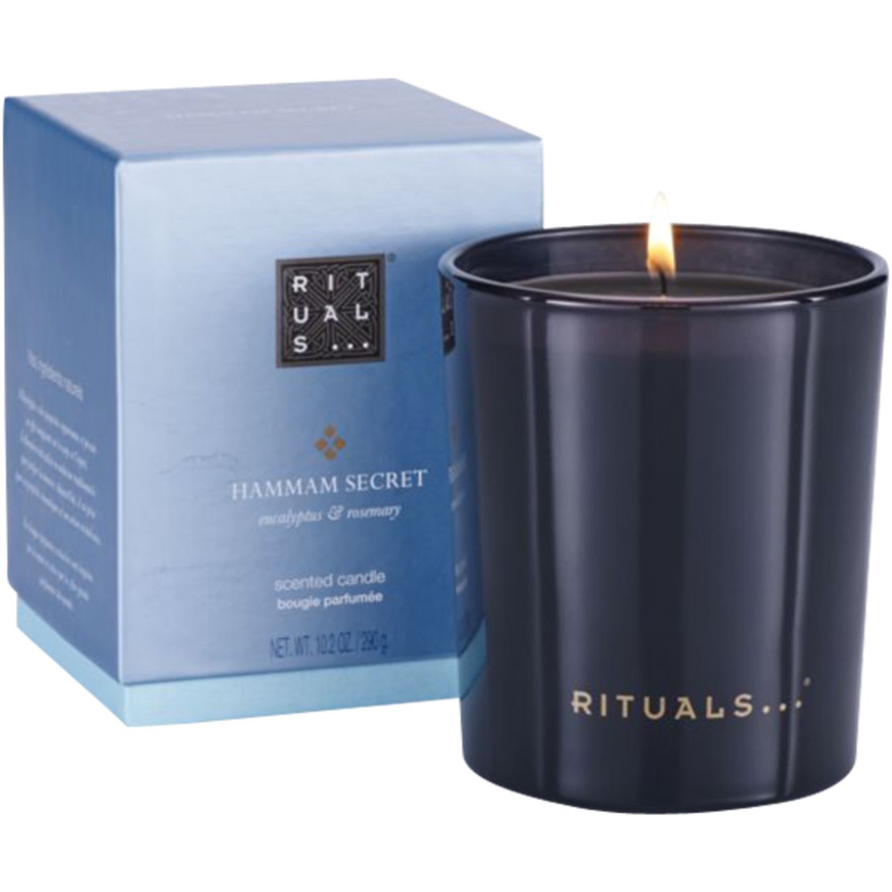 Dunkelblaue Kerze in Glas, daneben Schachtel. Aufschrift: Hammam Secret, Rituals. Kerze brennt.
