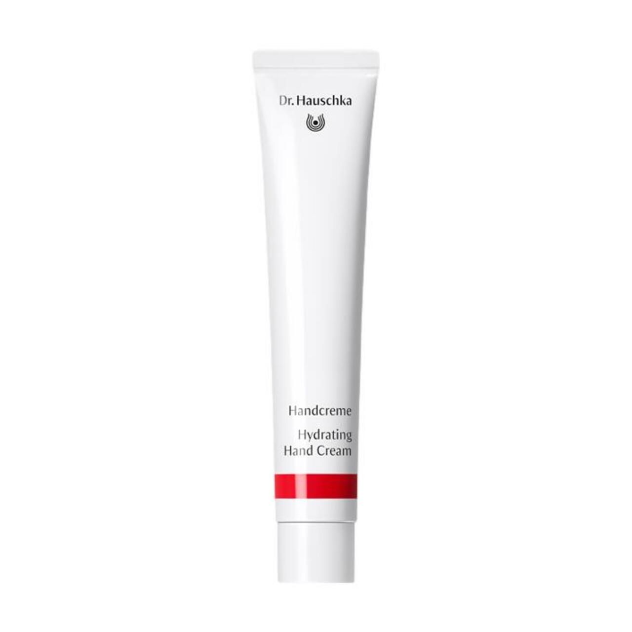 Weiße Tube mit rotem Streifen. Aufschrift: Dr. Hauschka, Handcreme, Hydrating Hand Cream.