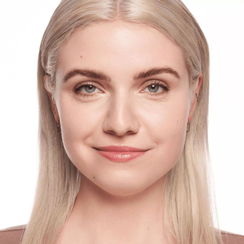 Porträt einer Frau mit hellem Teint. Sie trägt Concealer. Produktname nicht sichtbar.