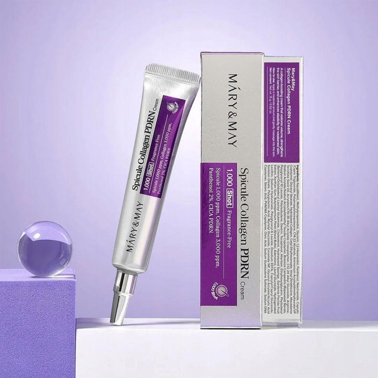 Mary&May Spicule Collagen PDRN Cream Tube und Karton neben dekorativen Elementen.