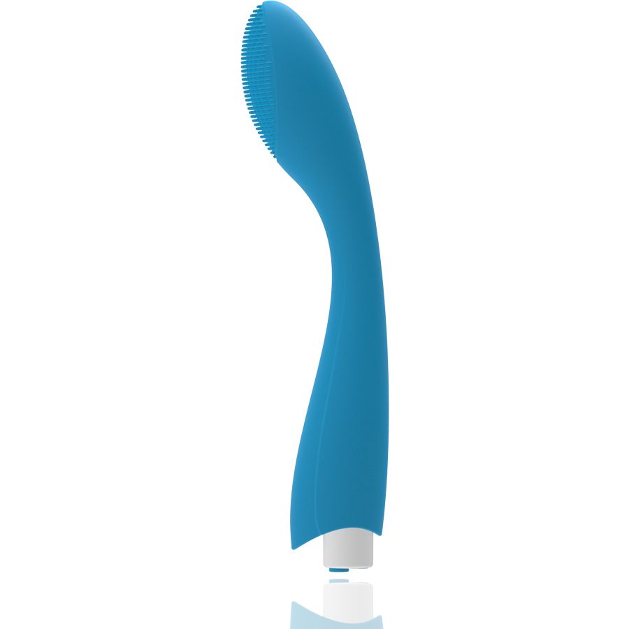 Blauer Vibrator mit gebogener Form. Ovaler Kopf mit geriffelter Oberfläche. Weißer Sockel.