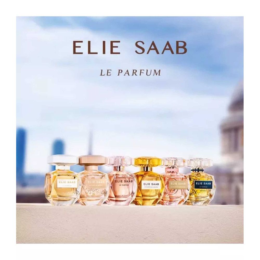 Mehrere Parfumflaschen. Aufschrift: Elie Saab, Le Parfum. Verschiedene Formen und Farben, vor blauem Himmel.