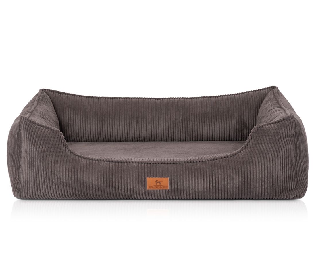 Orthopädisches Hundebett, grau, Cord-Optik. Rechteckige Form mit erhöhten Seiten. Kleines Logo-Etikett.