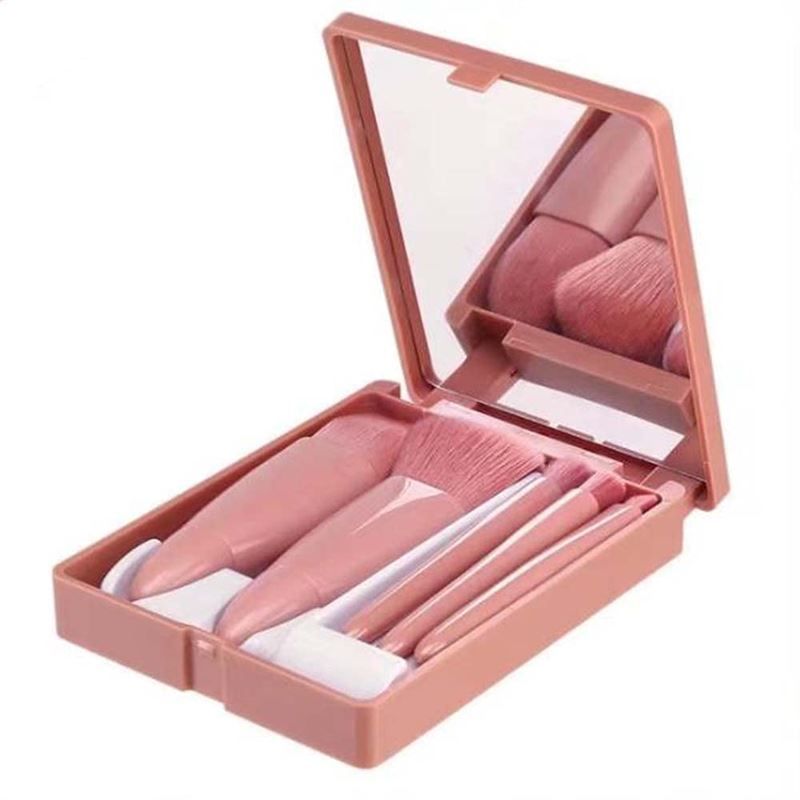 Rosa Reise-Makeup-Pinselset mit Spiegel. Enthält fünf Pinsel in einer rechteckigen, aufklappbaren Hülle mit Spiegel.