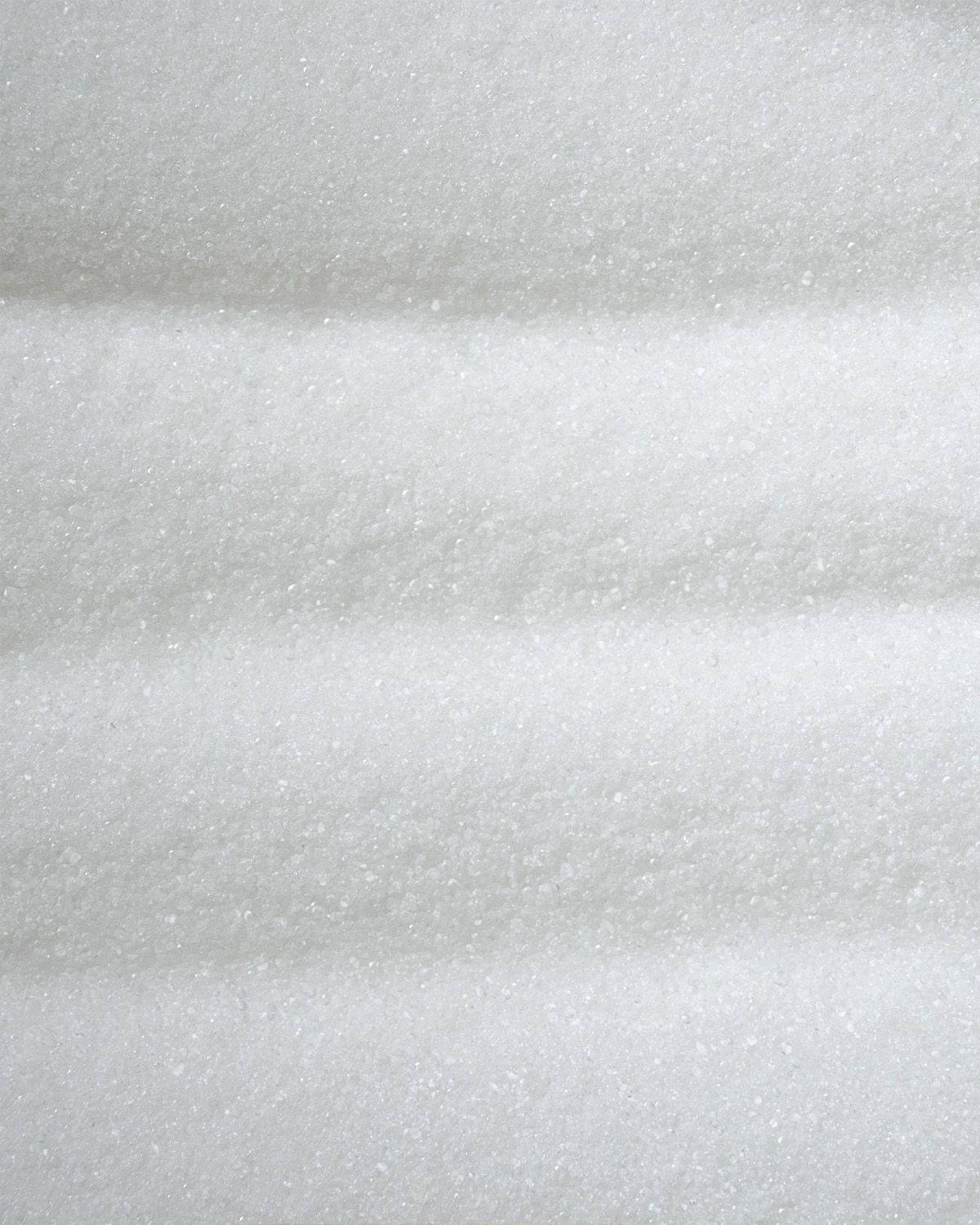 Nahaufnahme von feinem, weißem L-Glycin Pulver.