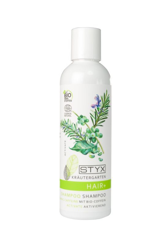 Weiße Shampoo-Flasche mit grünem Etikett. Aufschrift: STYX Kräutergarten HAIR+. Enthält Bio-Coffein. Mit floralem Design und Bio-Siegel.