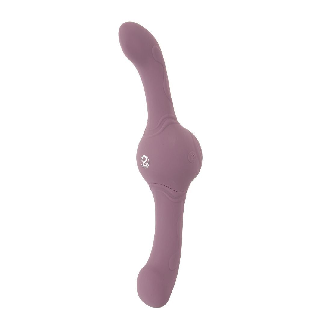 Lila Vibrator mit zwei gebogenen Enden und einem runden Mittelteil. Logo auf dem Mittelteil.