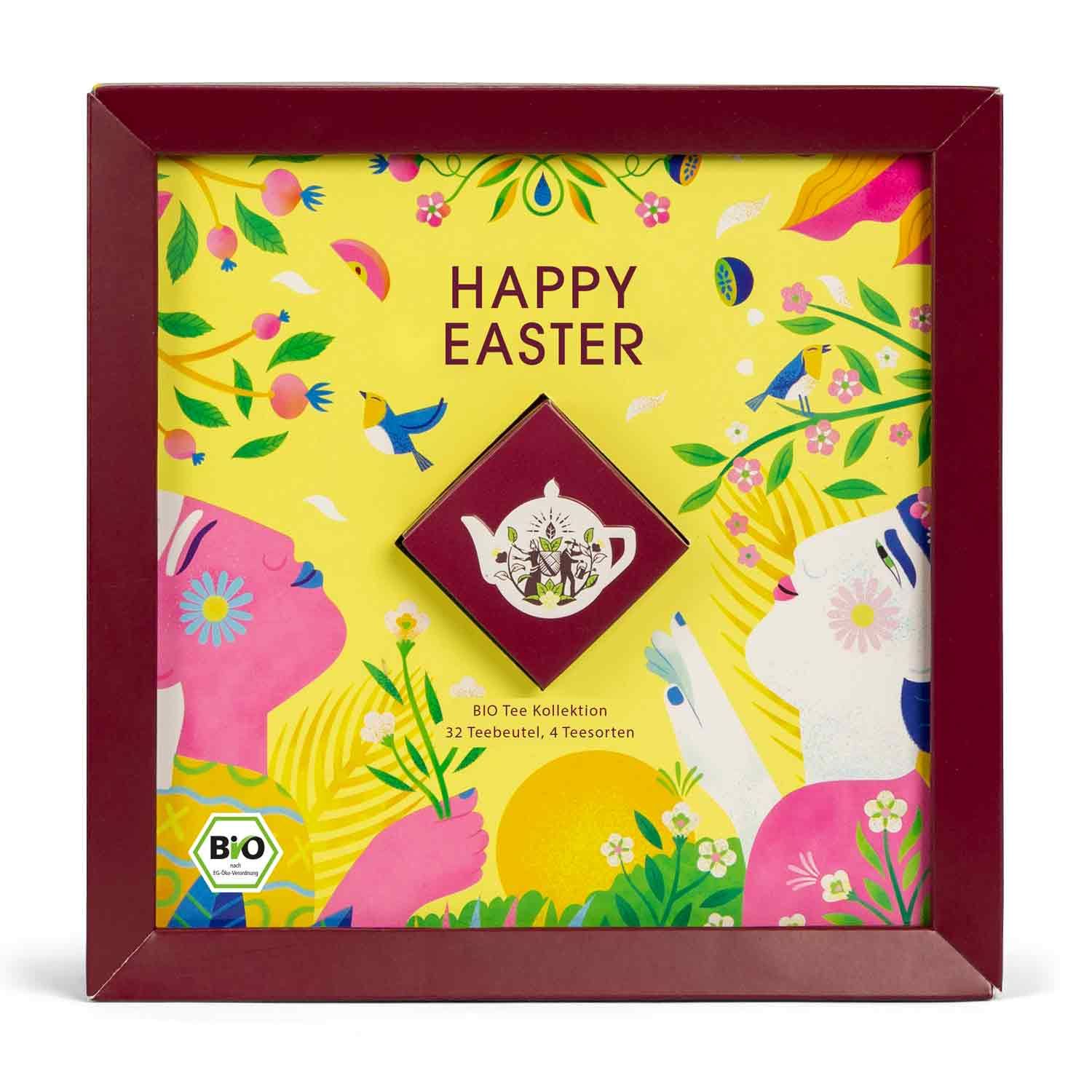 Geschenkbox mit "Happy Easter"-Aufdruck. Enthält eine kleine Schachtel mit Teebeuteln und eine Teekanne-Illustration. Bio-Siegel.