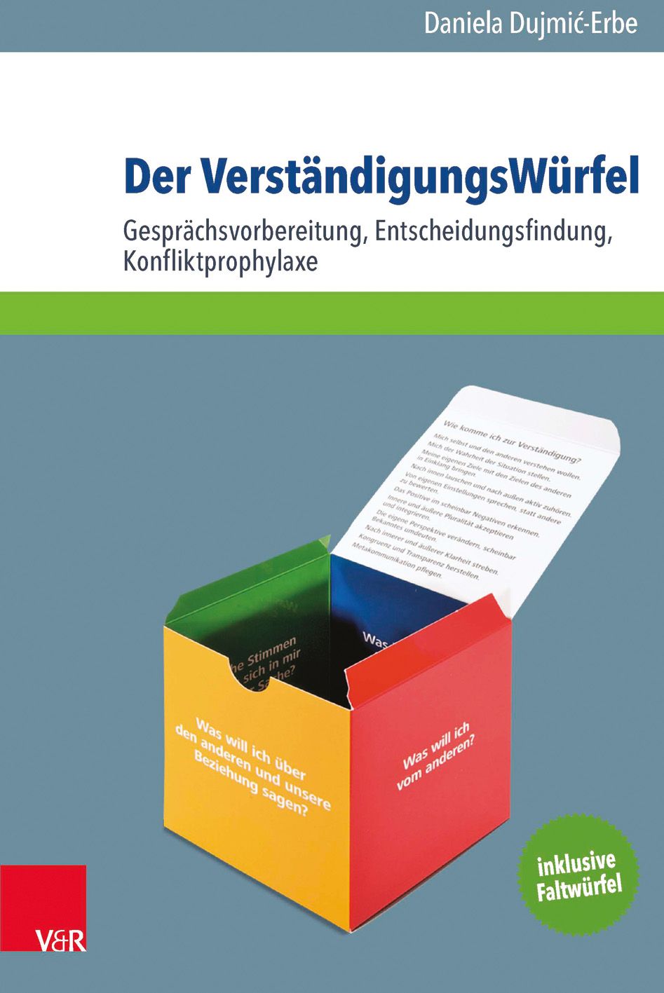 Buch mit Titel "Der VerständigungsWürfel". Aufschrift: Gesprächsvorbereitung, Entscheidungsfindung, Konfliktprophylaxe. Inklusive Faltwürfel.