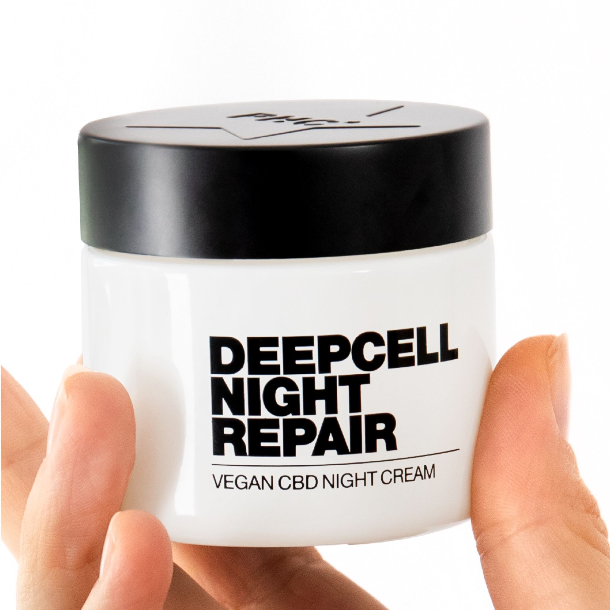Weiße Creme-Dose mit schwarzem Deckel. Schwarze Schrift: DEEPCELL NIGHT REPAIR. Vegan CBD Night Cream. Hände halten die Dose.