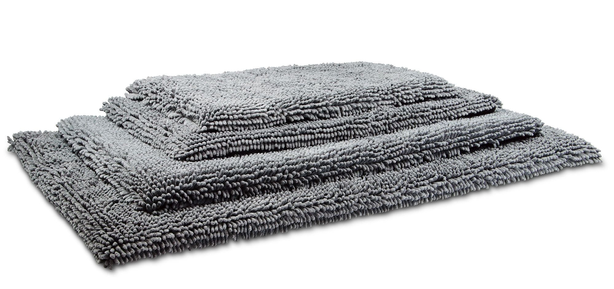 Graues Pad, rechteckig, aus flauschigem Material. Mehrere Pads gestapelt, unterschiedliche Größen. Wolters Cleankeeper Reise Pad.