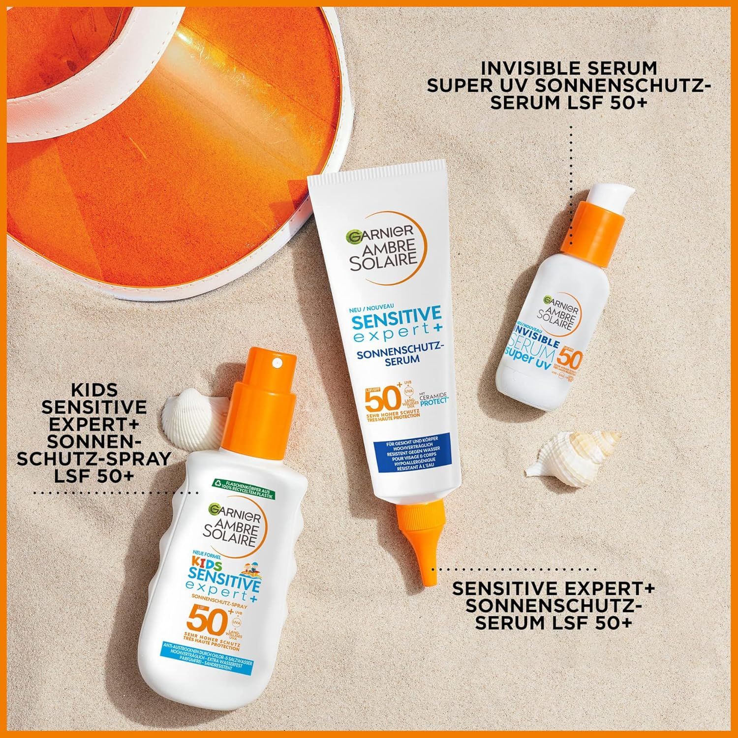 Drei Produkte: Garnier Ambre Solaire Sensitive Expert+ LSF50+ Sonnen-Serum, Spray und Serum. Auf Sand.