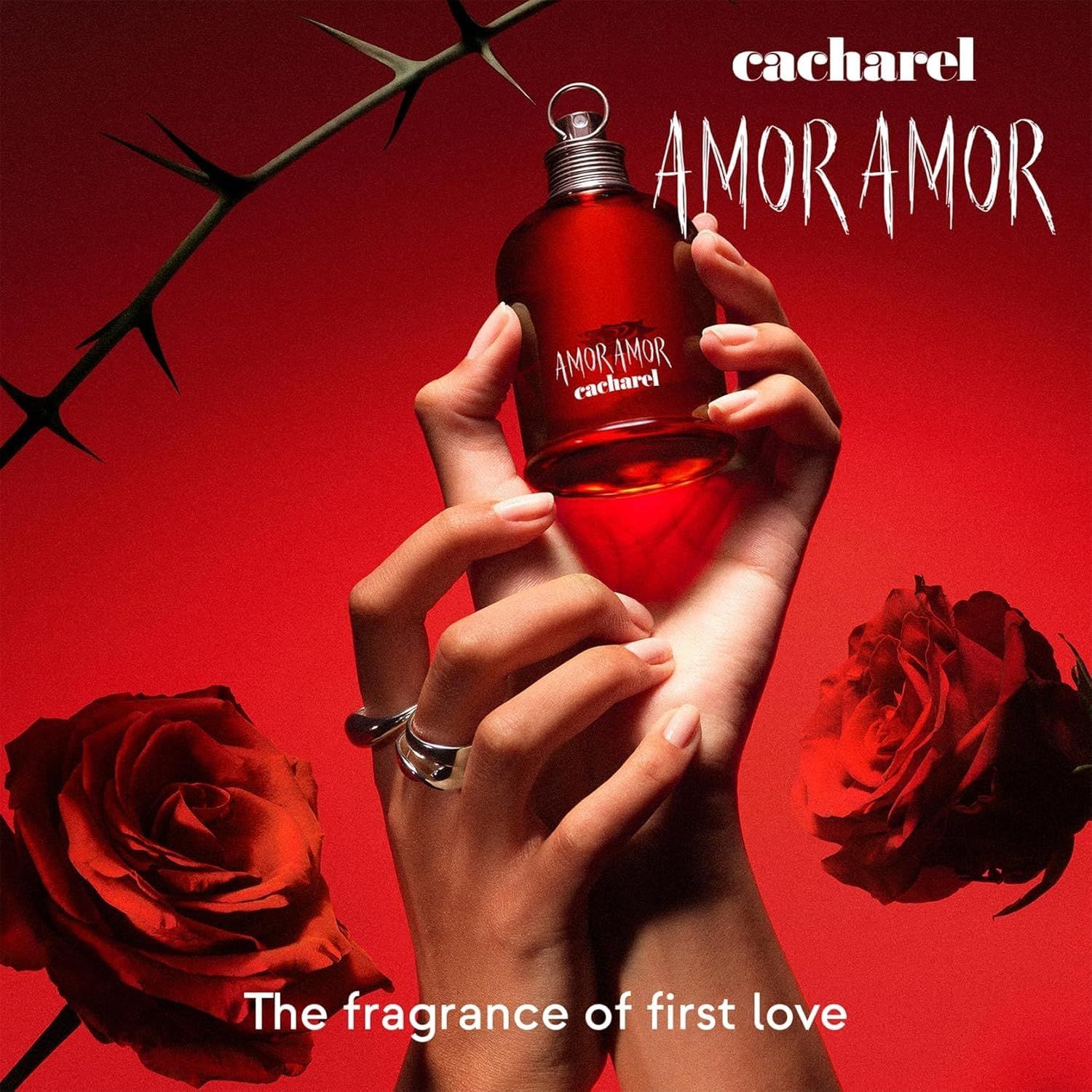 Roter Flakon, gehalten von Händen. Aufschrift: AMOR AMOR, darunter cacharel. Rosen und Dornen.