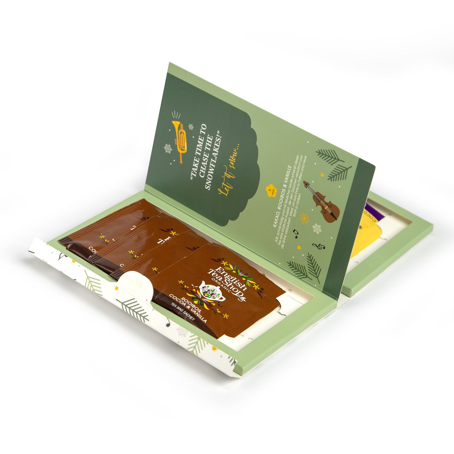 Geöffnete Teebox. Einzeln verpackte Teebeutel. Aufdruck: English Tea Shop. Aufschrift: Kakao, Rooibos & Vanille. Grün-weißes Design mit Musiknoten.