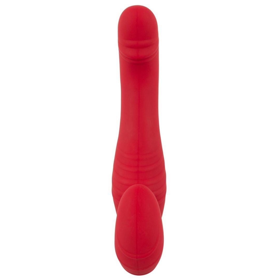Roter Vibrator mit gebogener Form. Das Gerät hat zwei abgerundete Enden und eine geriffelte Oberfläche.