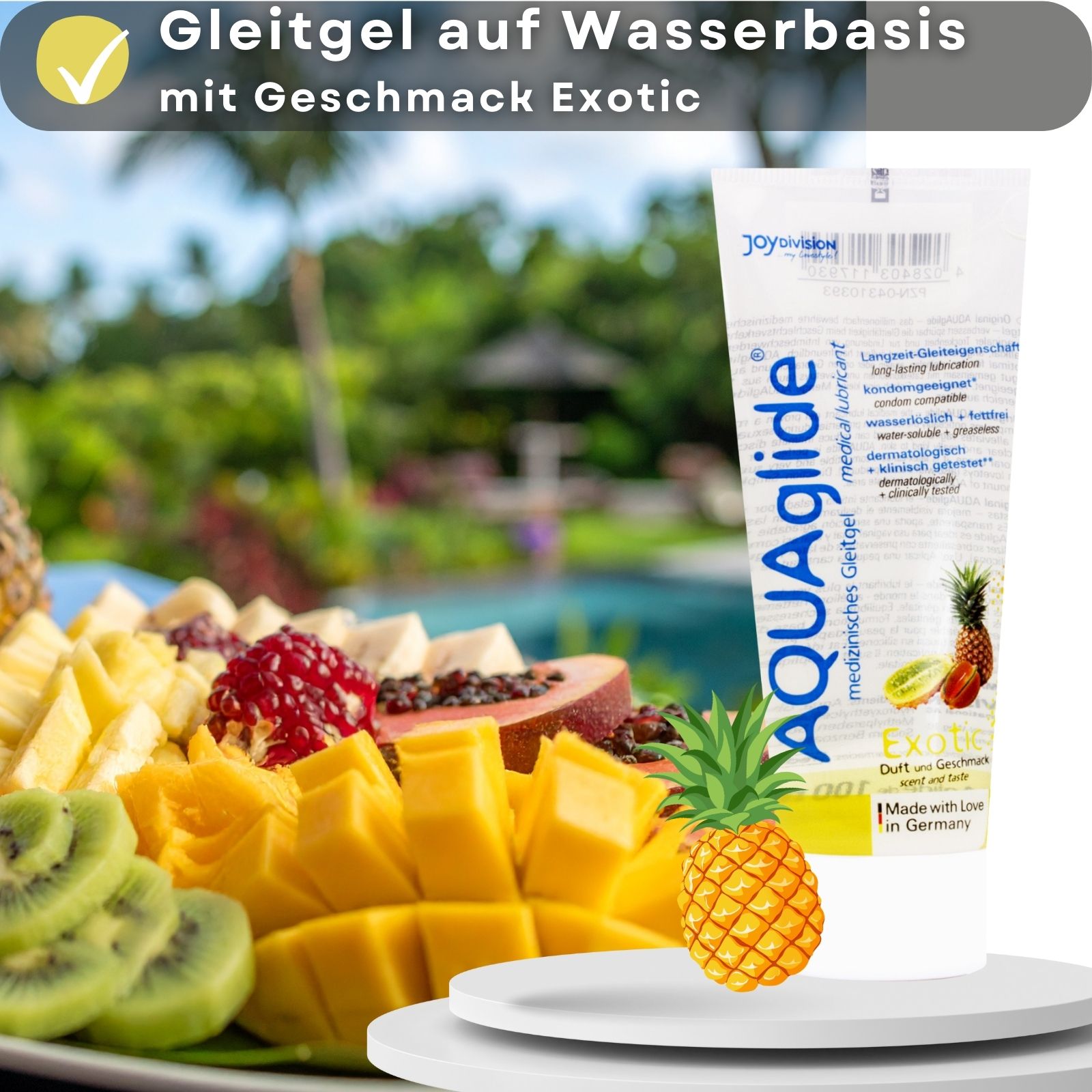 AQUAglide Gleitgel-Tube neben Obstplatte. Text: Gleitgel auf Wasserbasis mit Geschmack Exotic. Ananas- und Kiwi-Abbildung.