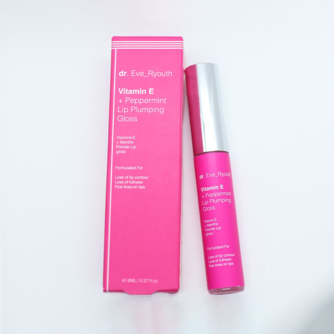 Rosa Lippenaufblähung und Verpackung. Aufschrift: Dr. Eve_Ryouth, Vitamin E + Pfefferminz. Produkt steht neben der Verpackung.