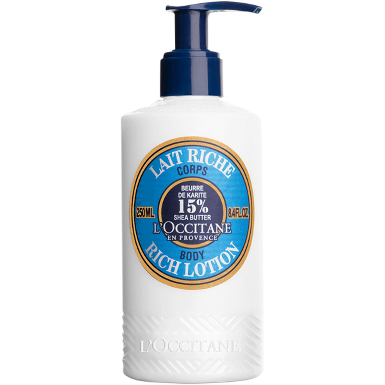 Weiße Flasche mit blauem Pumpkopf. Aufkleber mit Text: Lait Riche Corps, 15% Shea Butter, L'Occitane. 250ml, 8.4 fl.oz.