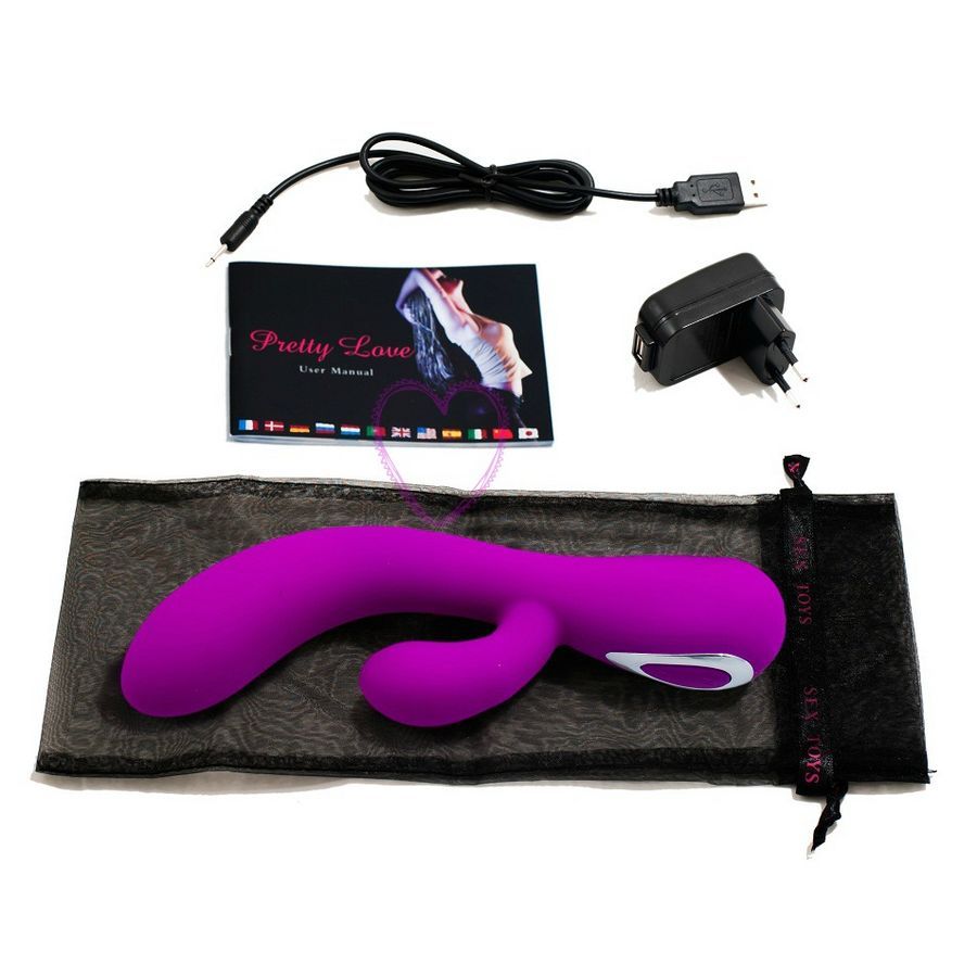 Lila Vibrator, USB-Kabel, Bedienungsanleitung, Netzteil und schwarzer Beutel. Auf weißem Hintergrund.