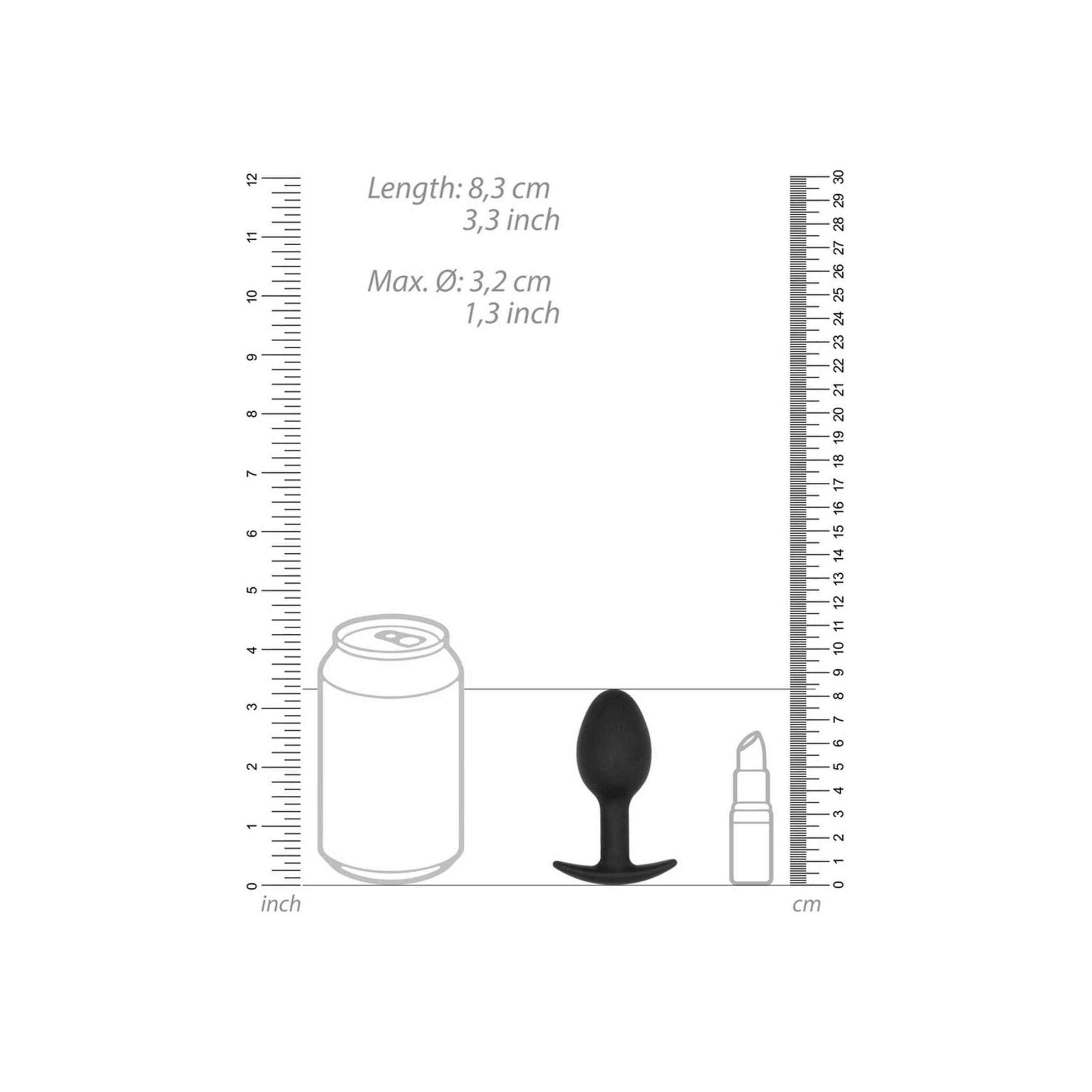 Schwarzer Butt Plug neben einer Dose und einem Lippenstift. Maße: 8,3 cm Länge, 3,2 cm Durchmesser.