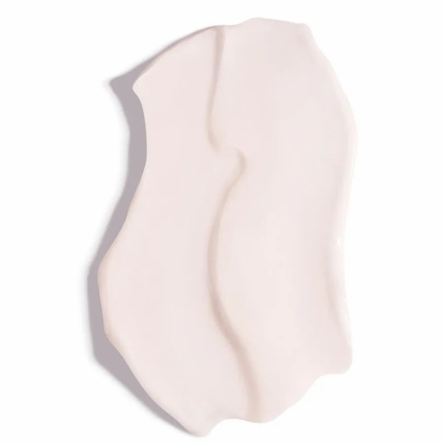 Nahaufnahme eines cremefarbenen Produkts. Die Textur ist glatt und wellenförmig aufgetragen.