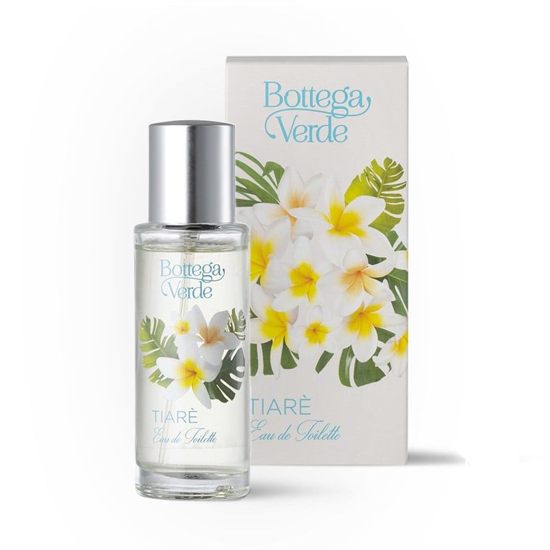 Bottega Verde Tiarè Eau de Toilette. Una bottiglia di vetro trasparente con tappo argentato è affiancata da una scatola bianca. Fiori bianchi con centri gialli e foglie verdi sono raffigurati sulla bottiglia e sulla scatola.