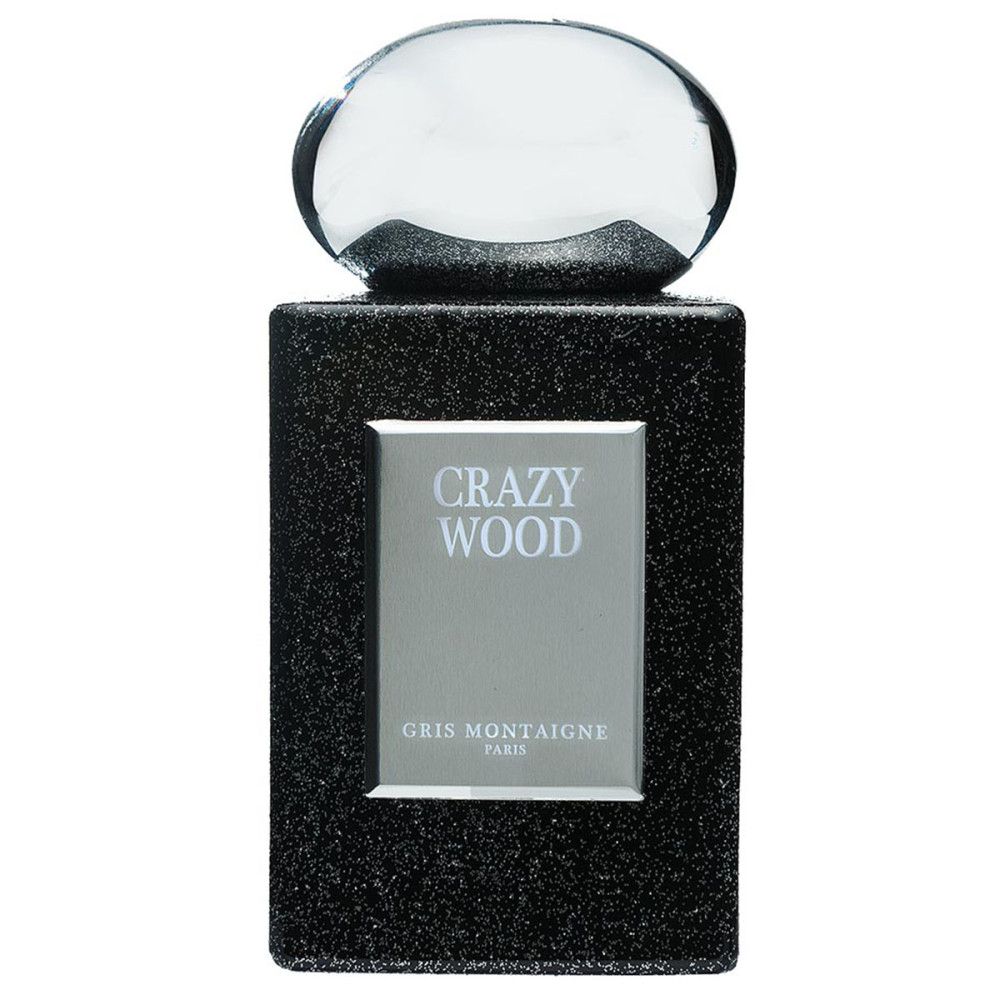 Dunkelgrauer Flakon mit silbernem Etikett. Aufschrift: CRAZY WOOD, GRIS MONTAIGNE PARIS. Transparenter Verschluss.