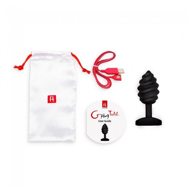 Zubehörset mit schwarzem Plug, weißem Beutel, USB-Kabel und Bedienungsanleitung. Der Plug hat eine spiralförmige Form.