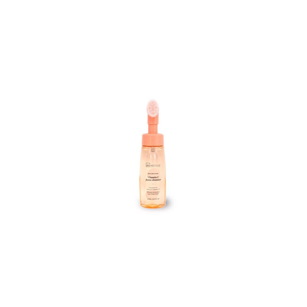 Flüssigreiniger mit Bürstenaufsatz. Transparente Flasche mit orangefarbenem Pumpkopf. Aufschrift nicht lesbar.