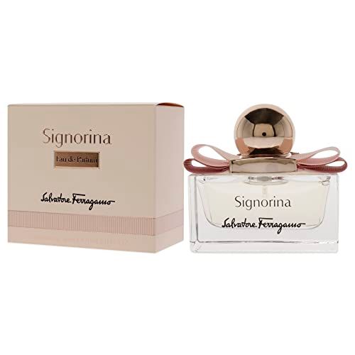 Signorina Eau de Parfum Spray. Rechteckiger Glasflakon mit rosa Flüssigkeit, rosa Schleife und goldfarbenem Verschluss. Verpackung daneben.
